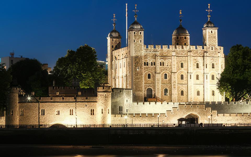 Photo of the Tower of London at night, taken from the Thames