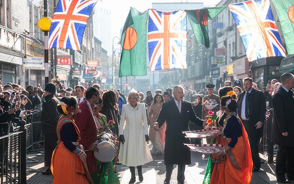 A photo of King Charles and Camilla visiting a high street in Tower Hamlets